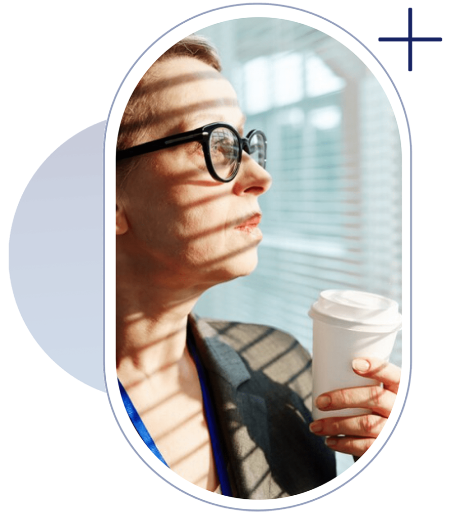 a young lady is thinking about Vision while having a cup of cofee in her hands